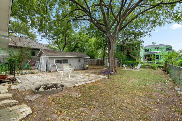 a view of a house with yard and sitting area