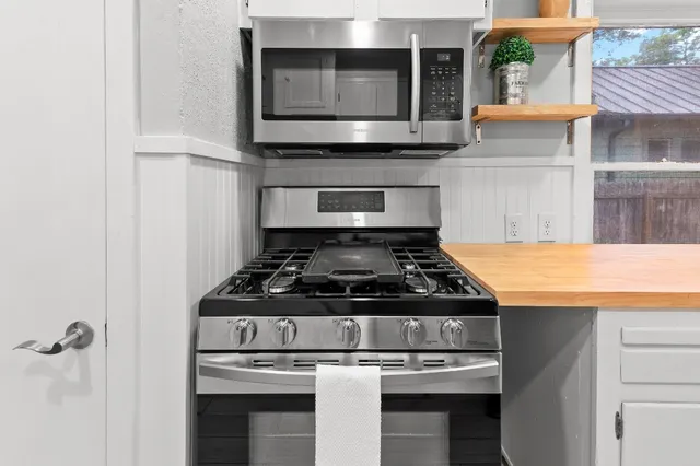 a stove top oven sitting inside of a kitchen