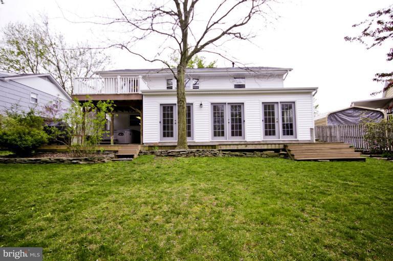 8245 Rupert Road South Millersville, MD 21108 - Photo 1 of 30 a view of a house with backyard porch and wooden fence