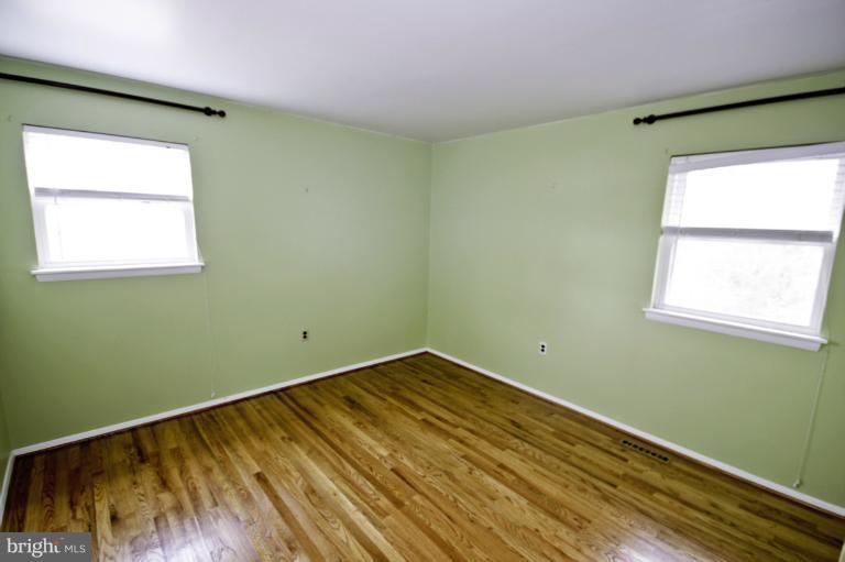 8245 Rupert Road South Millersville, MD 21108 - Photo 17 of 30 a view of a room with wooden floor and a window