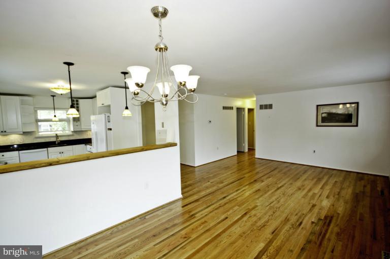 8245 Rupert Road South Millersville, MD 21108 - Photo 19 of 30 a view of a room with chandelier fan and wooden floor