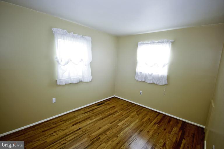 8245 Rupert Road South Millersville, MD 21108 - Photo 20 of 30 a view of a room with wooden floor and fan
