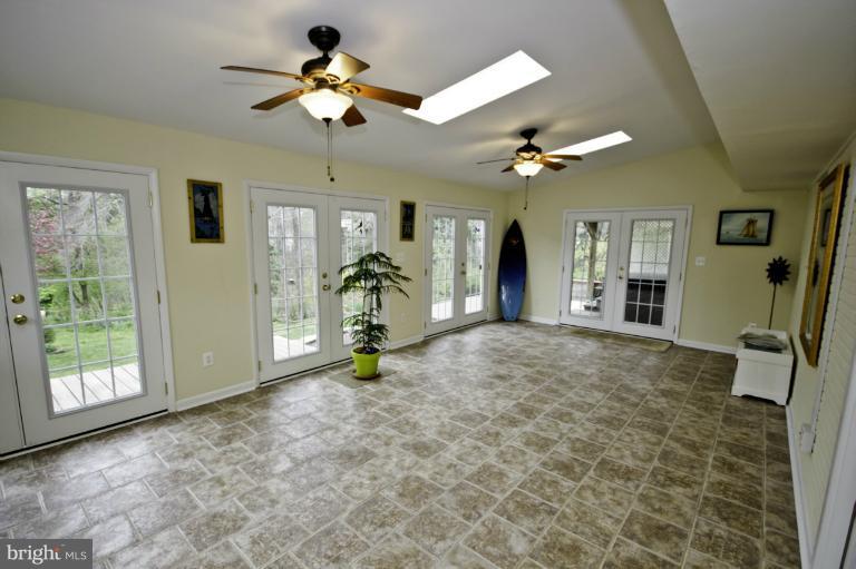 8245 Rupert Road South Millersville, MD 21108 - Photo 4 of 30 a view of a livingroom with a chandelier furniture and a ceiling fan