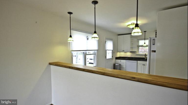 8245 Rupert Road South Millersville, MD 21108 - Photo 6 of 30 a kitchen with kitchen island a counter top space appliances and a floor