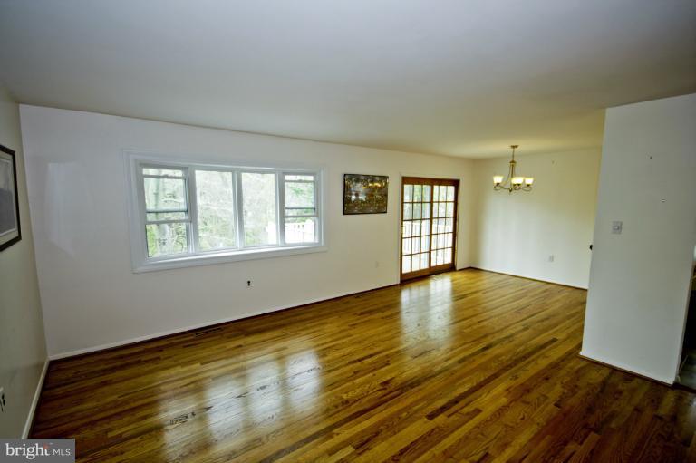 8245 Rupert Road South Millersville, MD 21108 - Photo 9 of 30 a view of an empty room with wooden floor and a window