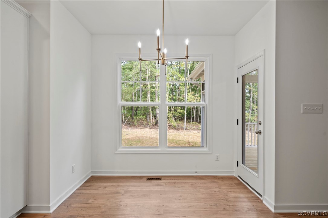 8506 Freebridge Road Chesterfield, VA 23832 - Photo 16 of 37 a view of an empty room with wooden floor and a window