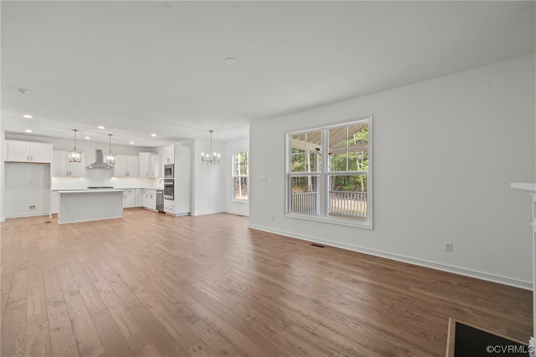 8506 Freebridge Road Chesterfield, VA 23832 - Photo 17 of 37 a view of an empty room with a window and wooden floor