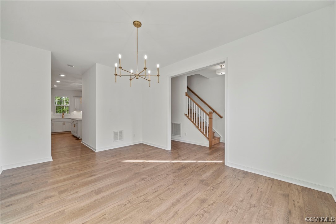 8506 Freebridge Road Chesterfield, VA 23832 - Photo 5 of 37 a view of a room with wooden floor staircase and a kitchen