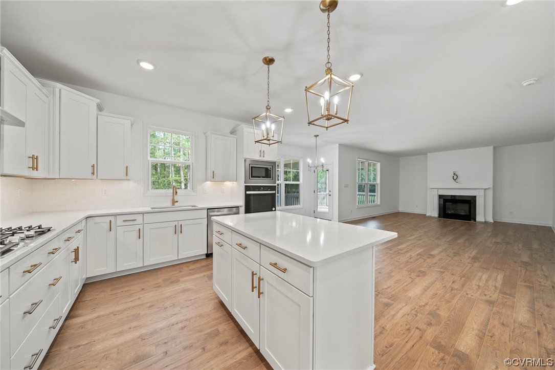 8506 Freebridge Road Chesterfield, VA 23832 - Photo 9 of 37 a large white kitchen with a stove oven and a sink with cabinets