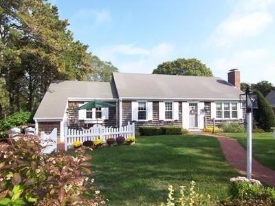 2 Trout Brook Road Harwich, MA 02645 - Photo 1 of 21 a front view of a house with a garden