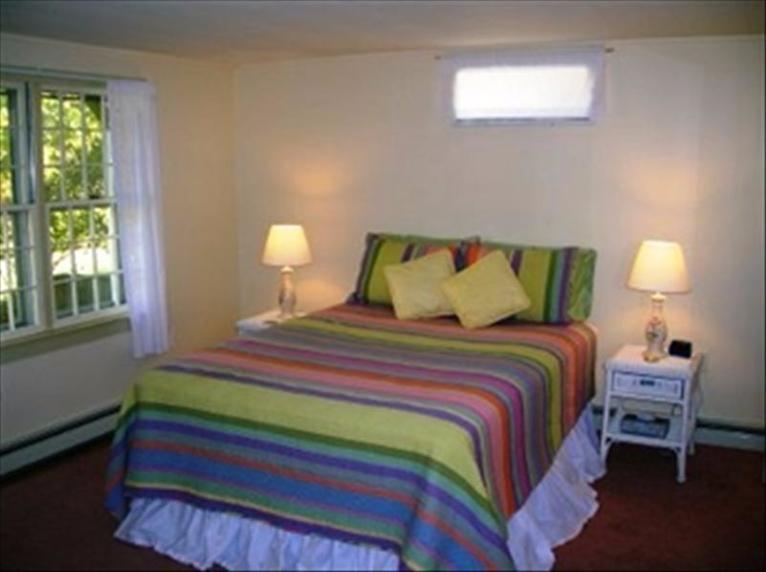 2 Trout Brook Road Harwich, MA 02645 - Photo 13 of 21 a bedroom with a bed and a lamp next to a window