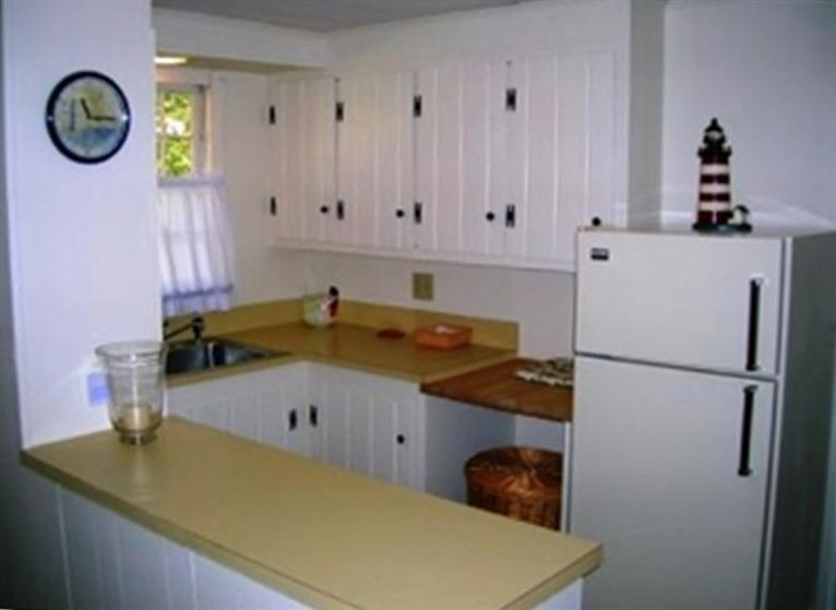 2 Trout Brook Road Harwich, MA 02645 - Photo 8 of 21 a bathroom with a sink and a refrigerator