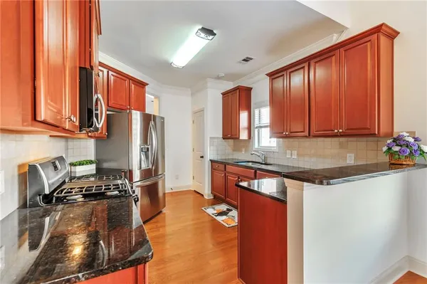 a kitchen with a sink stove and cabinets