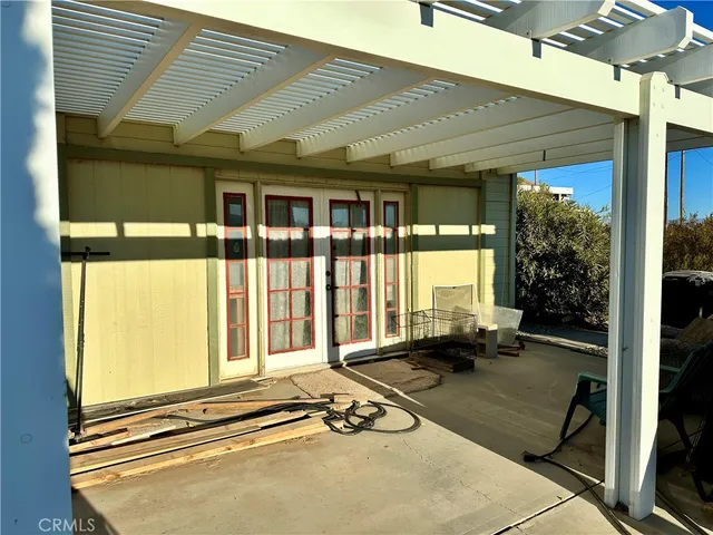 a view of a balcony with a floor to ceiling window and wooden floor