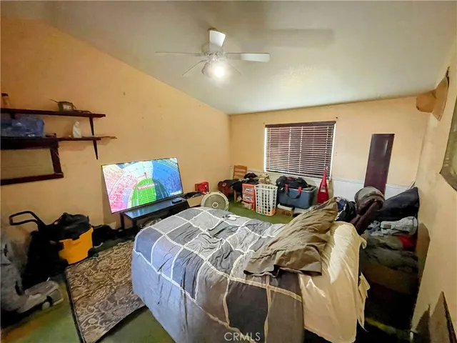 a bed room with two bed and a flat screen tv