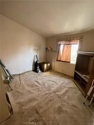 a bedroom with a bed and a tv