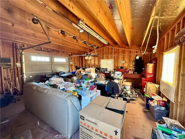 a view of a room with lots of furniture and clutter