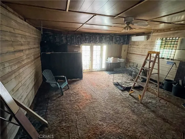 a yellow room with wooden floor and furniture