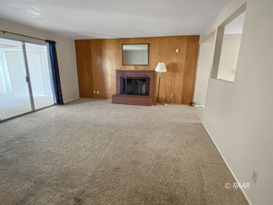 312 North Norma Street Ridgecrest, CA 93555 - Photo 2 of 18 an empty room with windows and a fireplace