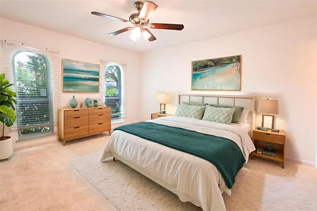 a bedroom with a bed and a large window