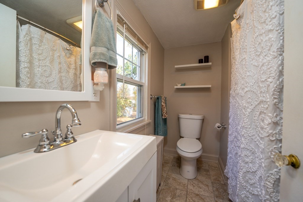 44 Hillside Avenue West Springfield, MA 01089 - Photo 22 of 34 a bathroom with a sink a toilet and a large mirror