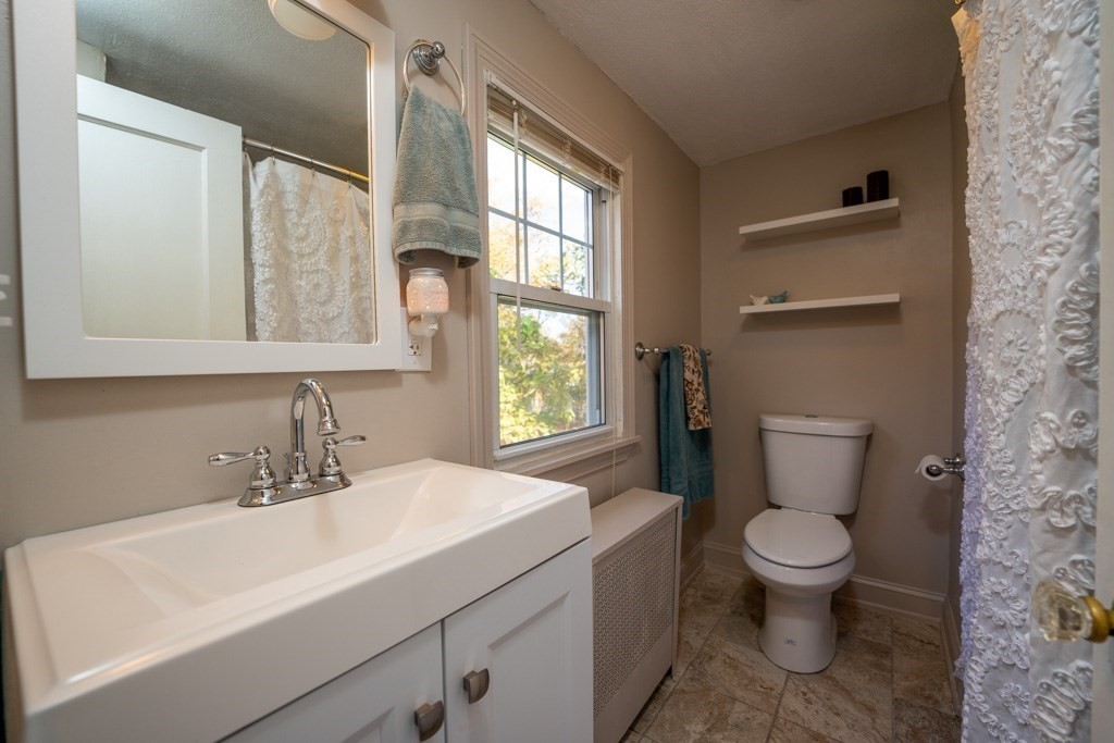 44 Hillside Avenue West Springfield, MA 01089 - Photo 23 of 34 a bathroom with a sink a toilet and a mirror