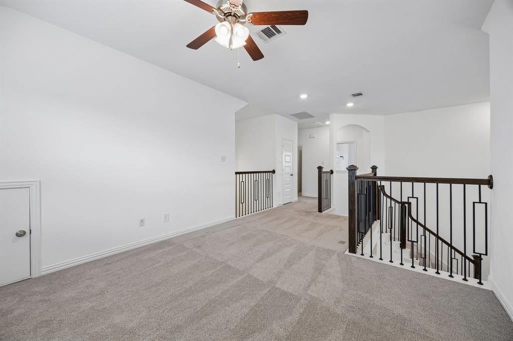 1303 Wheelwright Drive Forney, TX 75126 - Photo 28 of 39 Spacious carpeted landing featuring a ceiling fan, recessed lighting, white walls, and a contemporary black iron stair railing