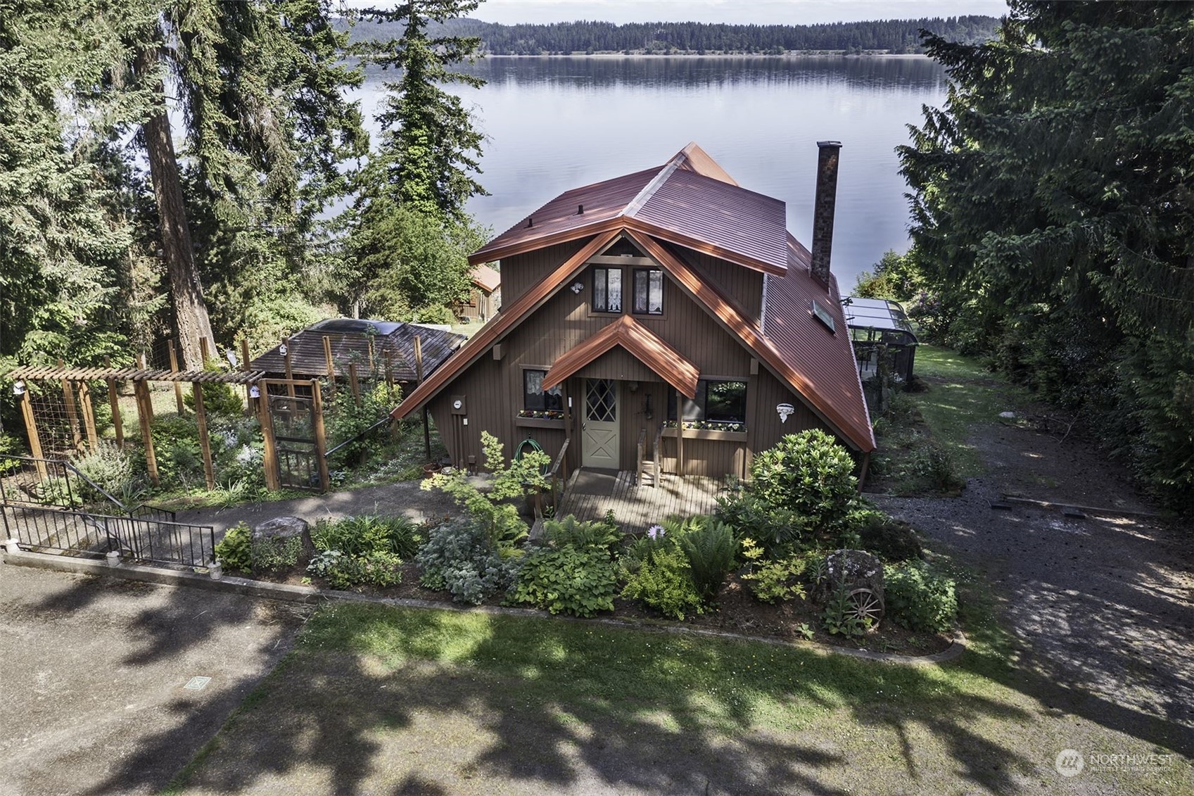 14125 Lyle Point Road Anderson Island, WA 98303 - Photo 1 of 38 a front view of a house with a garden