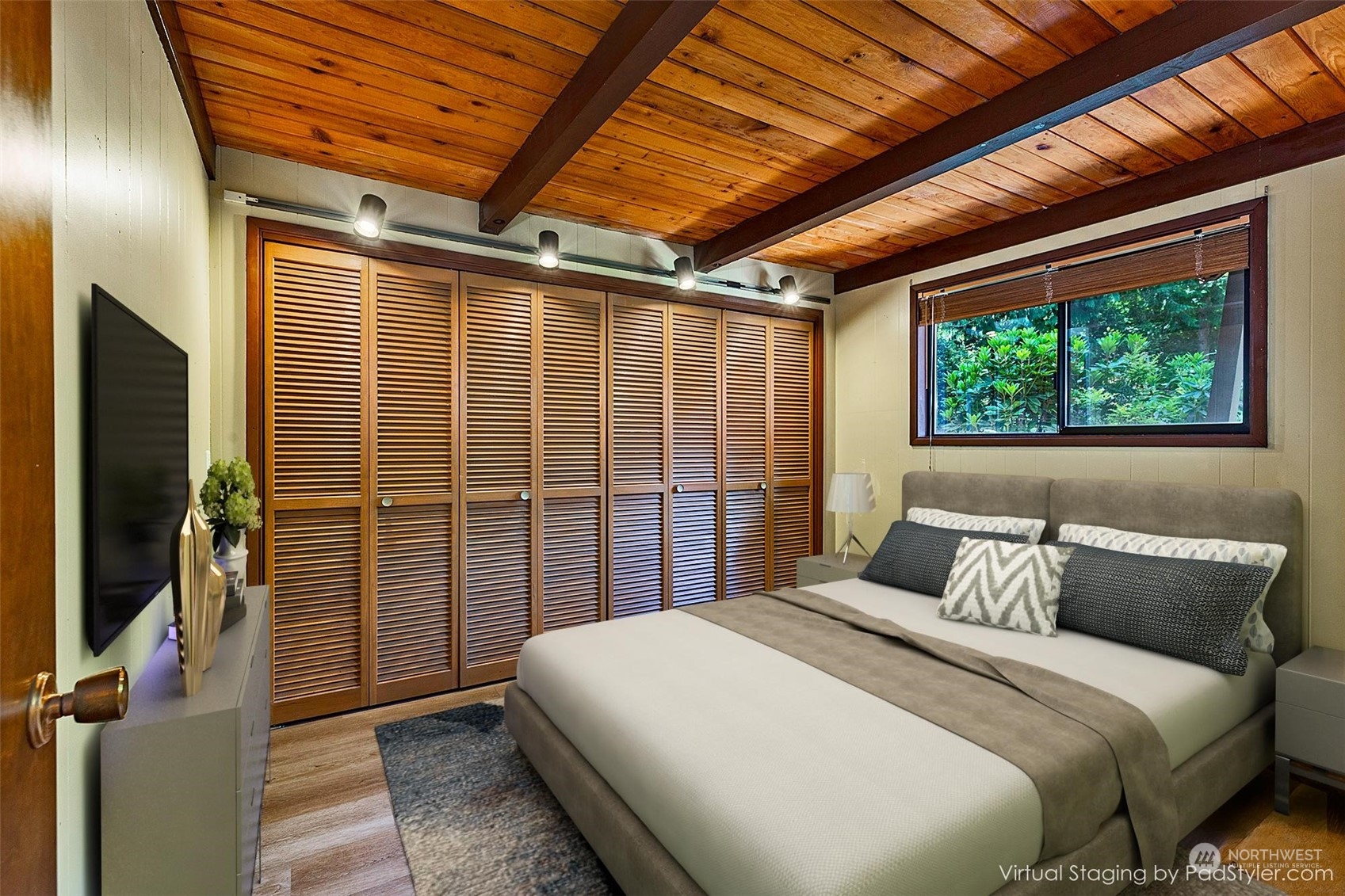 14125 Lyle Point Road Anderson Island, WA 98303 - Photo 17 of 38 a bedroom with a large bed and a large window