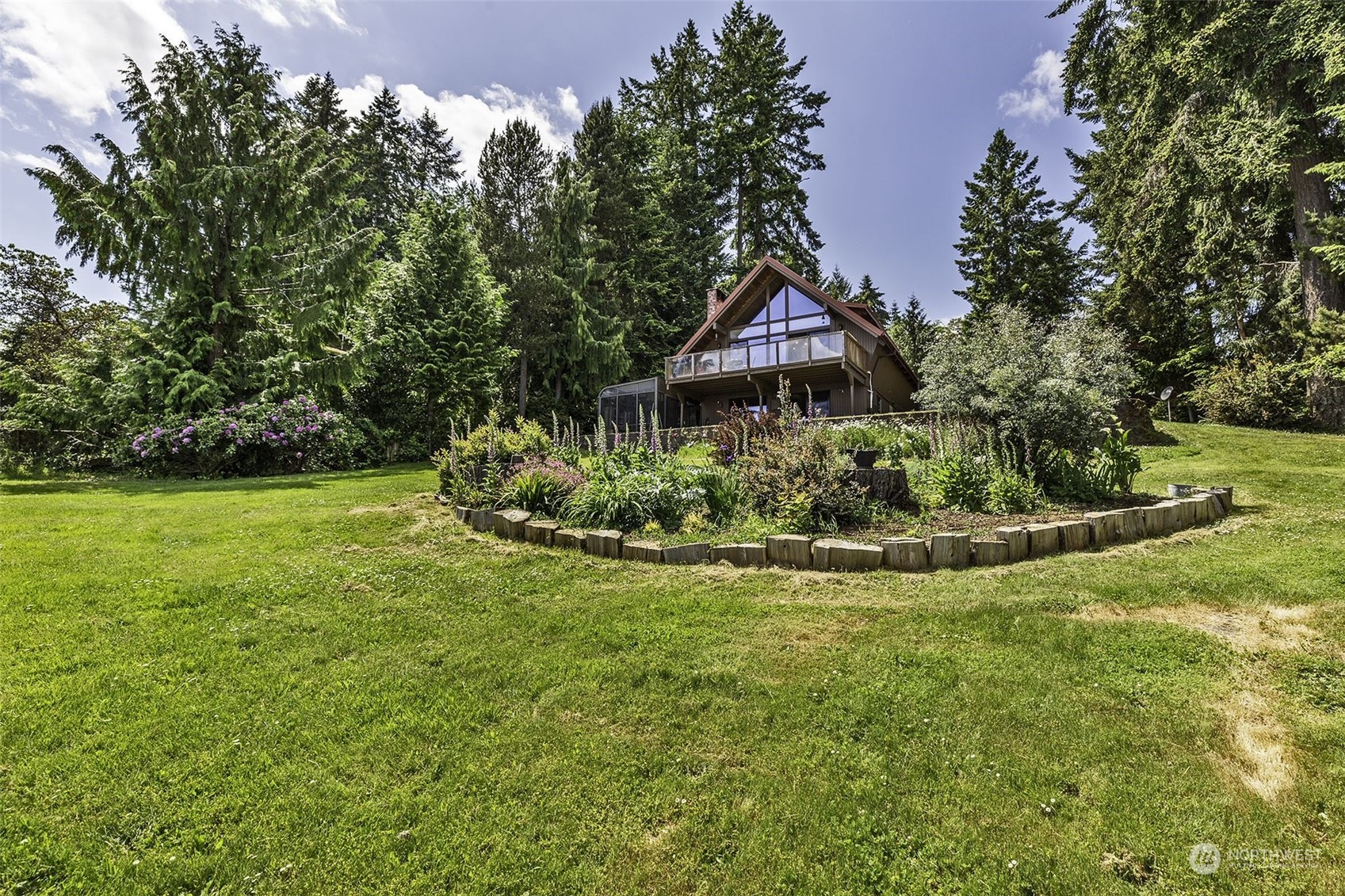 14125 Lyle Point Road Anderson Island, WA 98303 - Photo 2 of 38 a view of a garden with a fountain