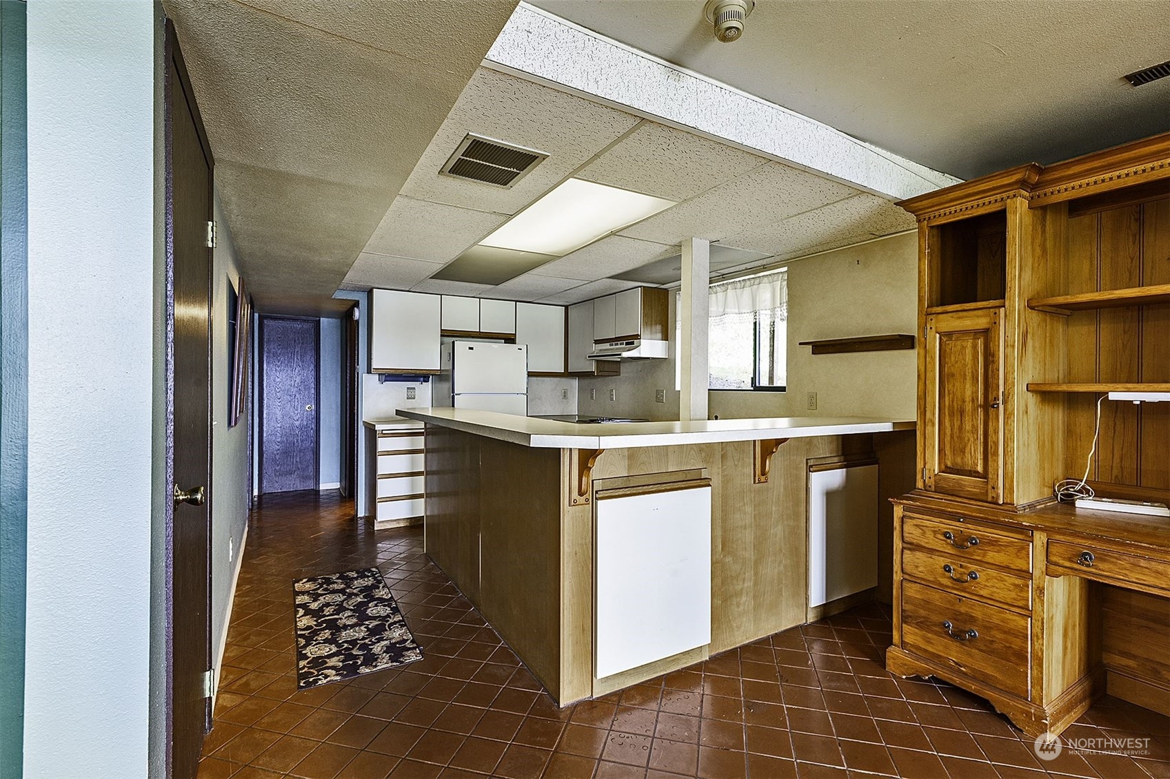 14125 Lyle Point Road Anderson Island, WA 98303 - Photo 23 of 38 a kitchen with kitchen island granite countertop a sink cabinets and stainless steel appliances