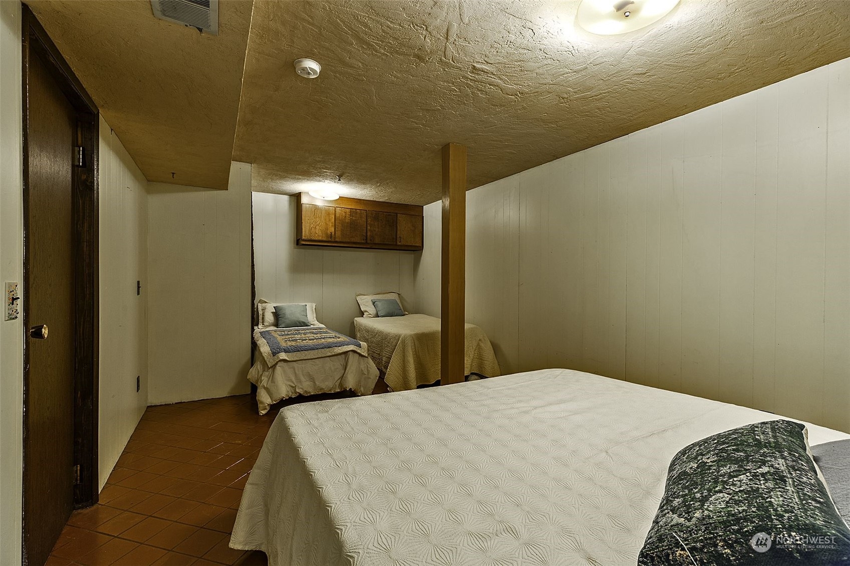 14125 Lyle Point Road Anderson Island, WA 98303 - Photo 26 of 38 a bedroom with a bed and chandelier