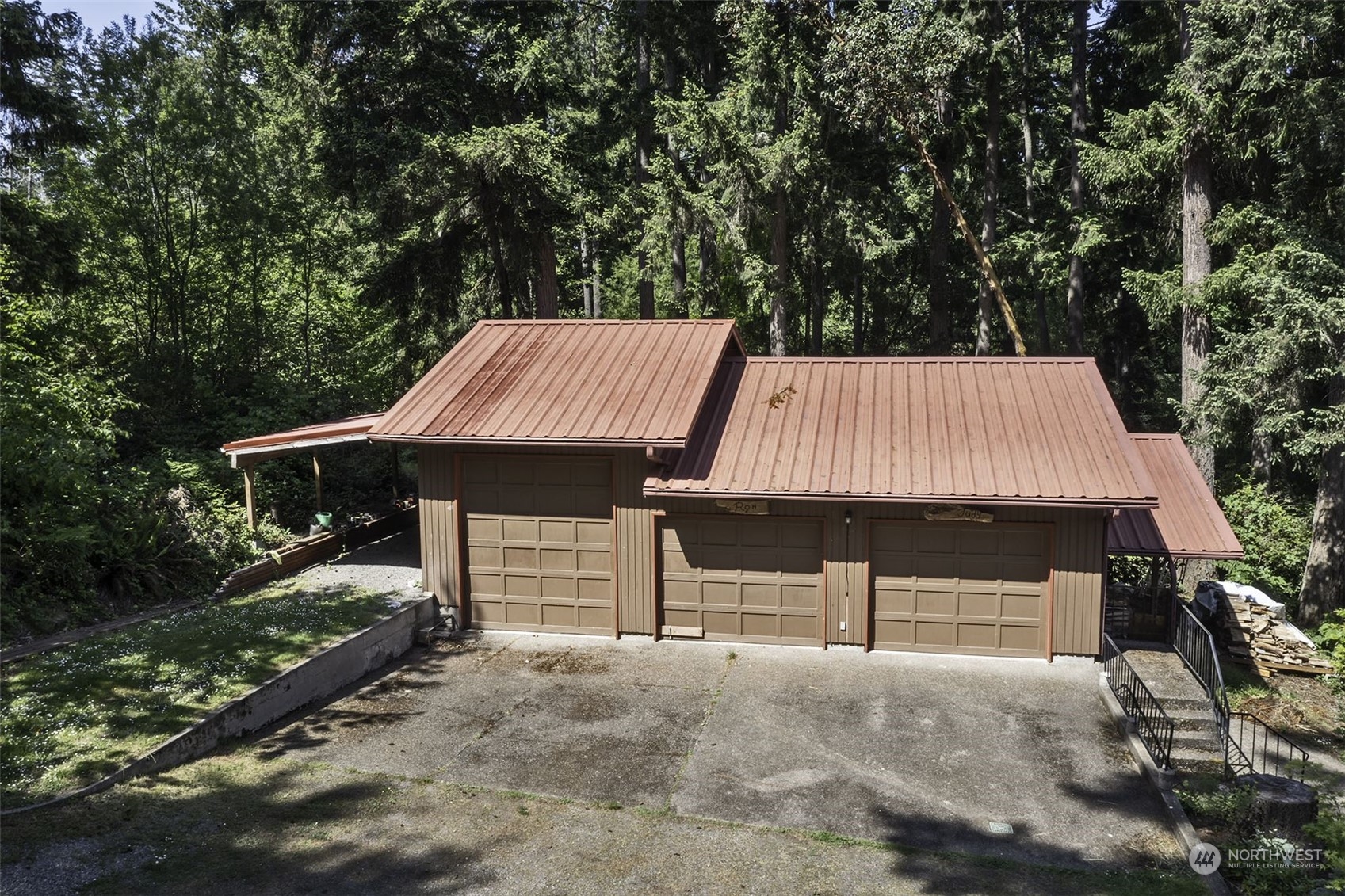 14125 Lyle Point Road Anderson Island, WA 98303 - Photo 8 of 38 a view of a house with a yard and garage