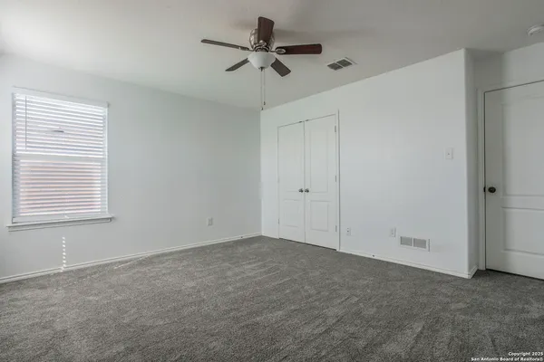 a view of room with a ceiling fan