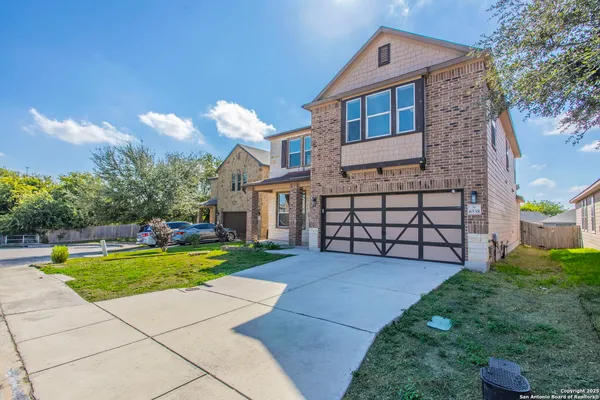 a view of a house with a yard and a garden