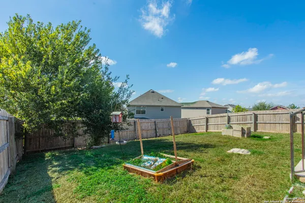 a backyard of a house with table and chairs