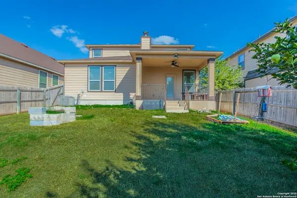 a view of a house with a yard and sitting area