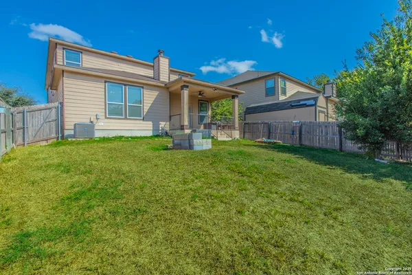 a view of a house with a yard and porch