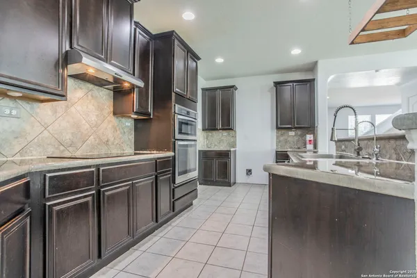 a kitchen with stainless steel appliances granite countertop a sink and cabinets