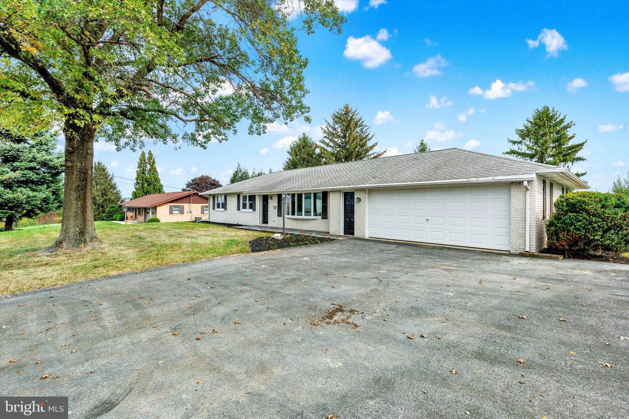 1227 Lebanon Road Manheim, PA 17545 - Photo 31 of 31 a front view of a house with a garden and yard