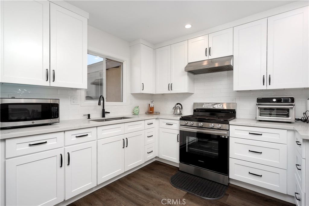 38859 Mesquite Road Palmdale, CA 93551 - Photo 3 of 36 a kitchen with white cabinets and appliances