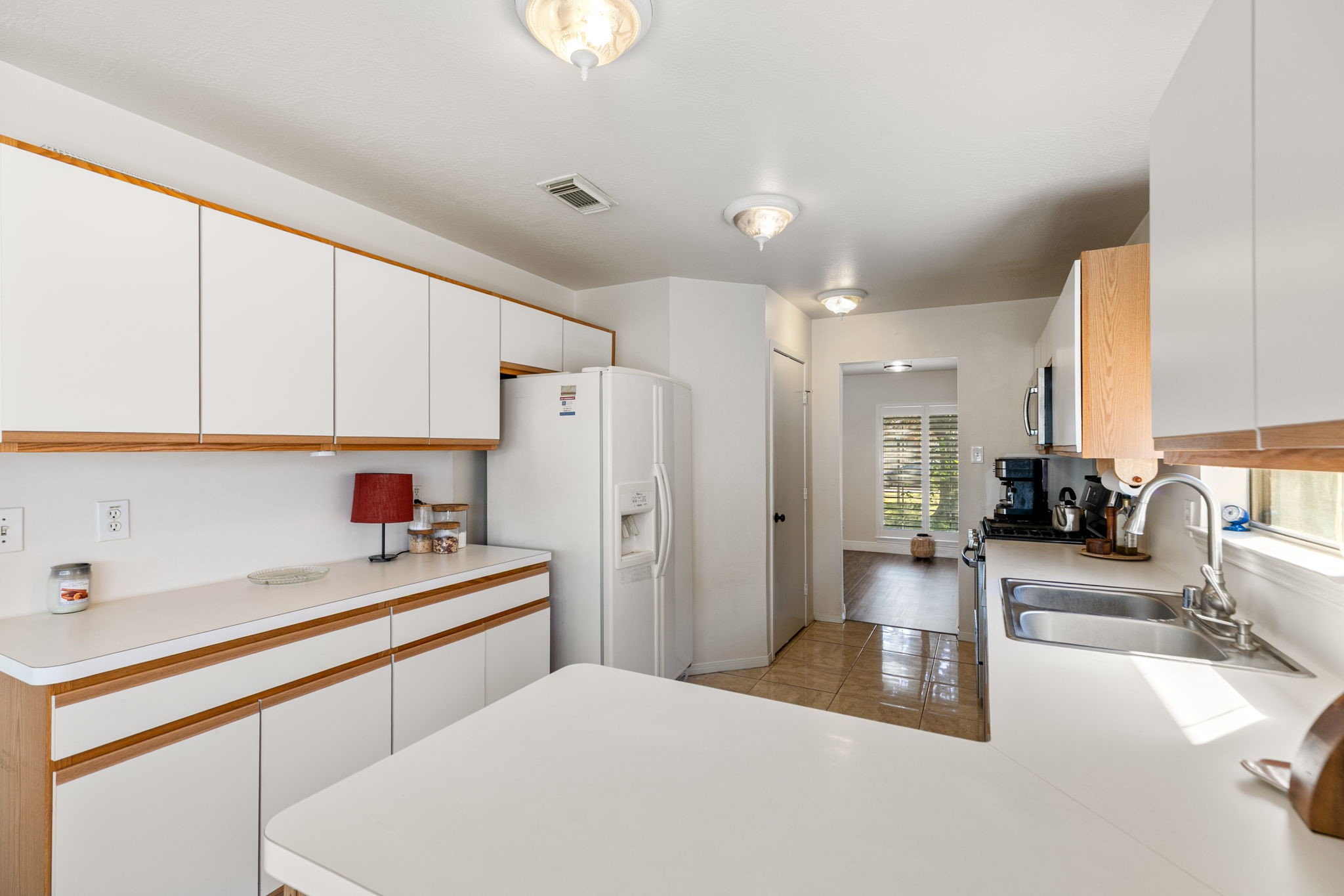 3714 Colleen Woods Circle Houston, TX 77080 - Photo 16 of 29 a kitchen with stainless steel appliances a sink a refrigerator and cabinets