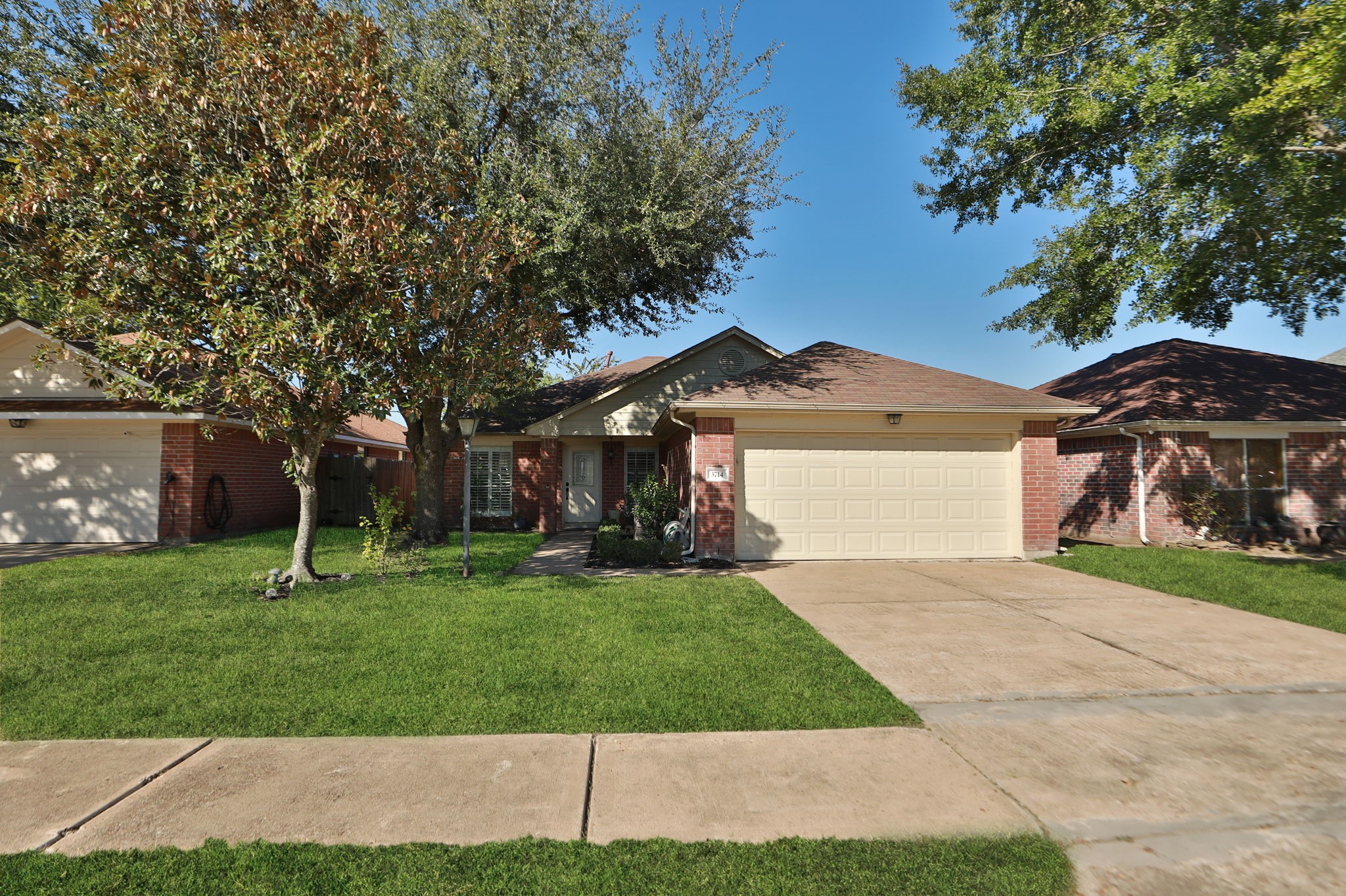 3714 Colleen Woods Circle Houston, TX 77080 - Photo 2 of 29 a front view of a house with a yard and trees