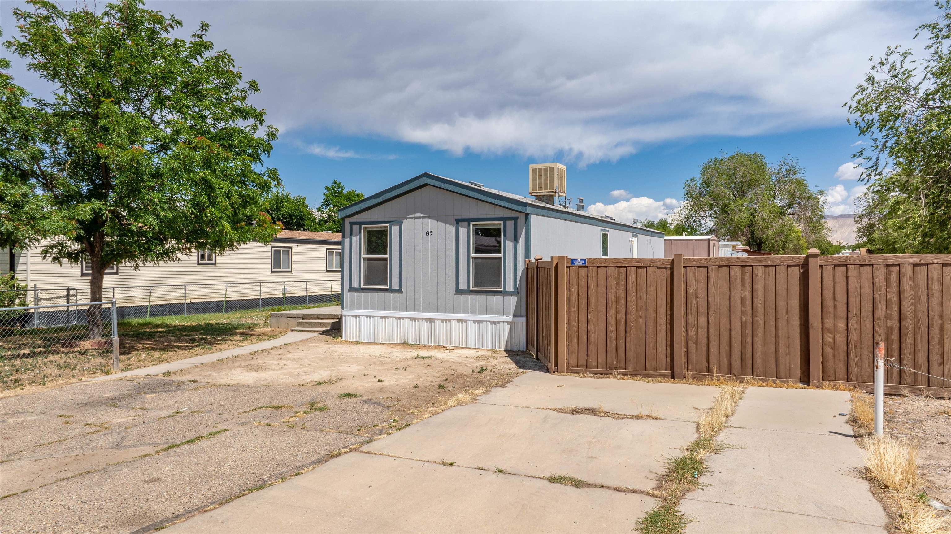 424 32 Road, Unit 85 Clifton, CO 81520 - Photo 1 of 12 a house with trees in the background