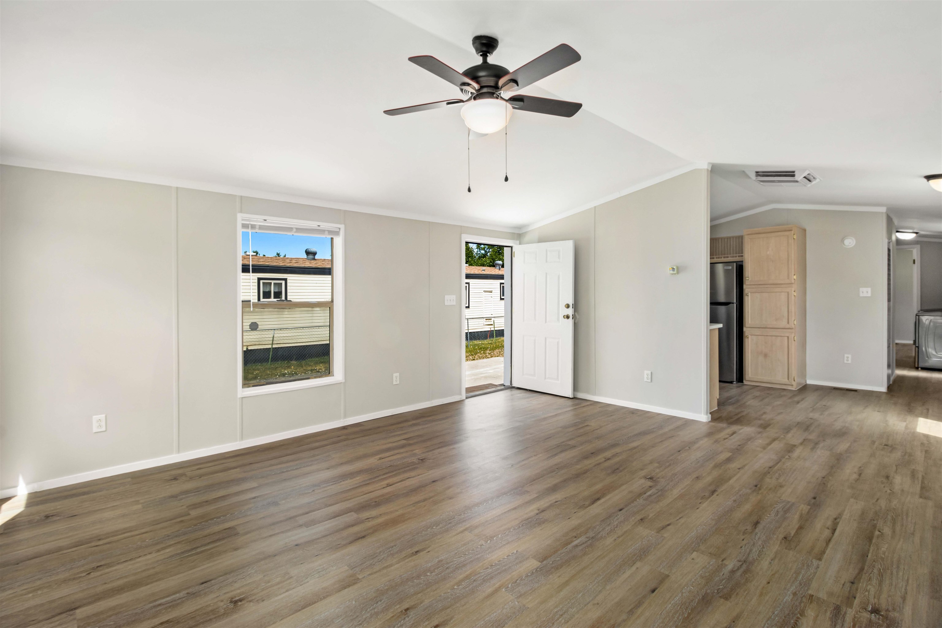 424 32 Road, Unit 85 Clifton, CO 81520 - Photo 2 of 12 a view of an empty room with a window and wooden floor
