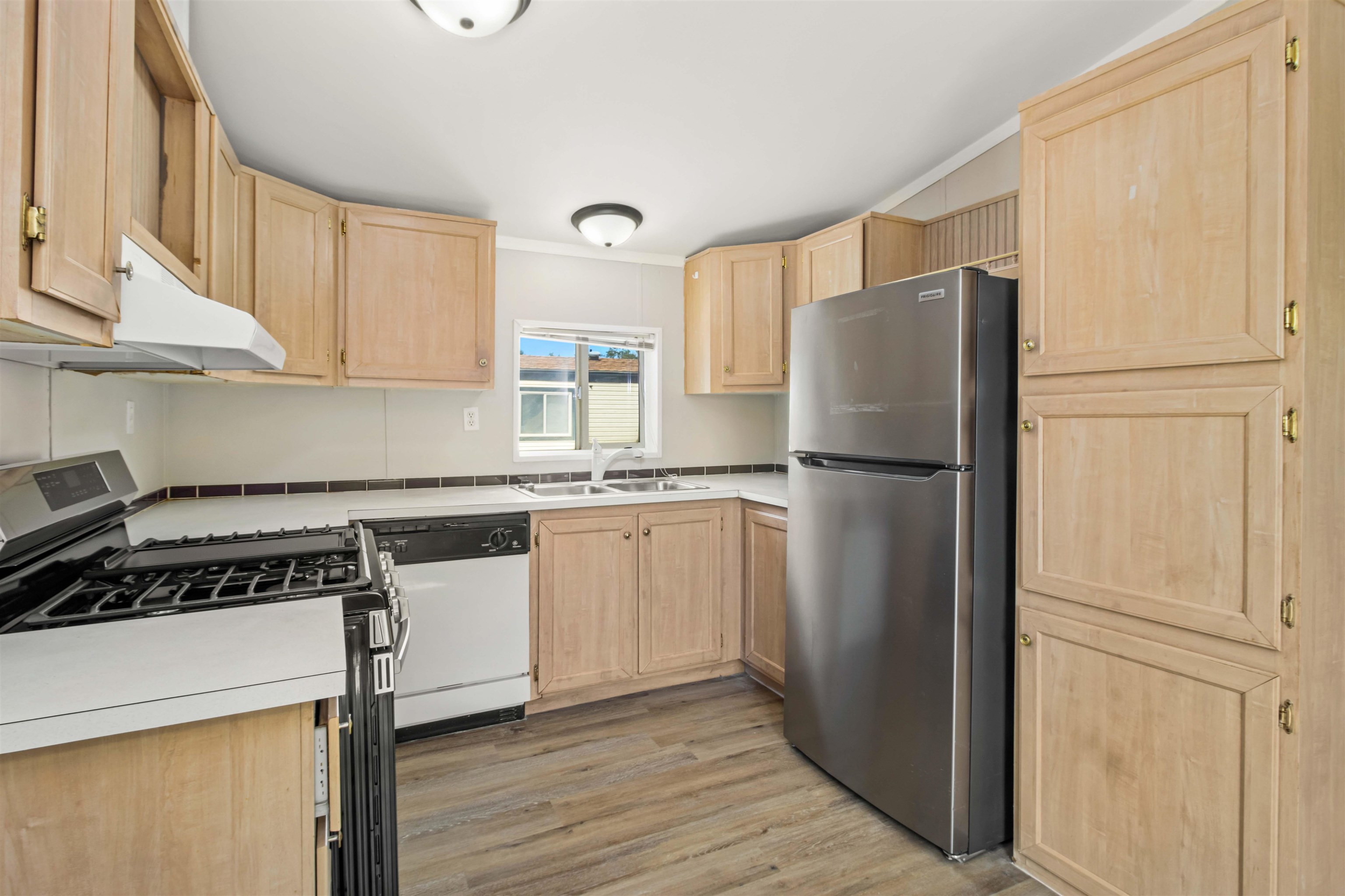 424 32 Road, Unit 85 Clifton, CO 81520 - Photo 4 of 12 a kitchen with a refrigerator a stove and white cabinets
