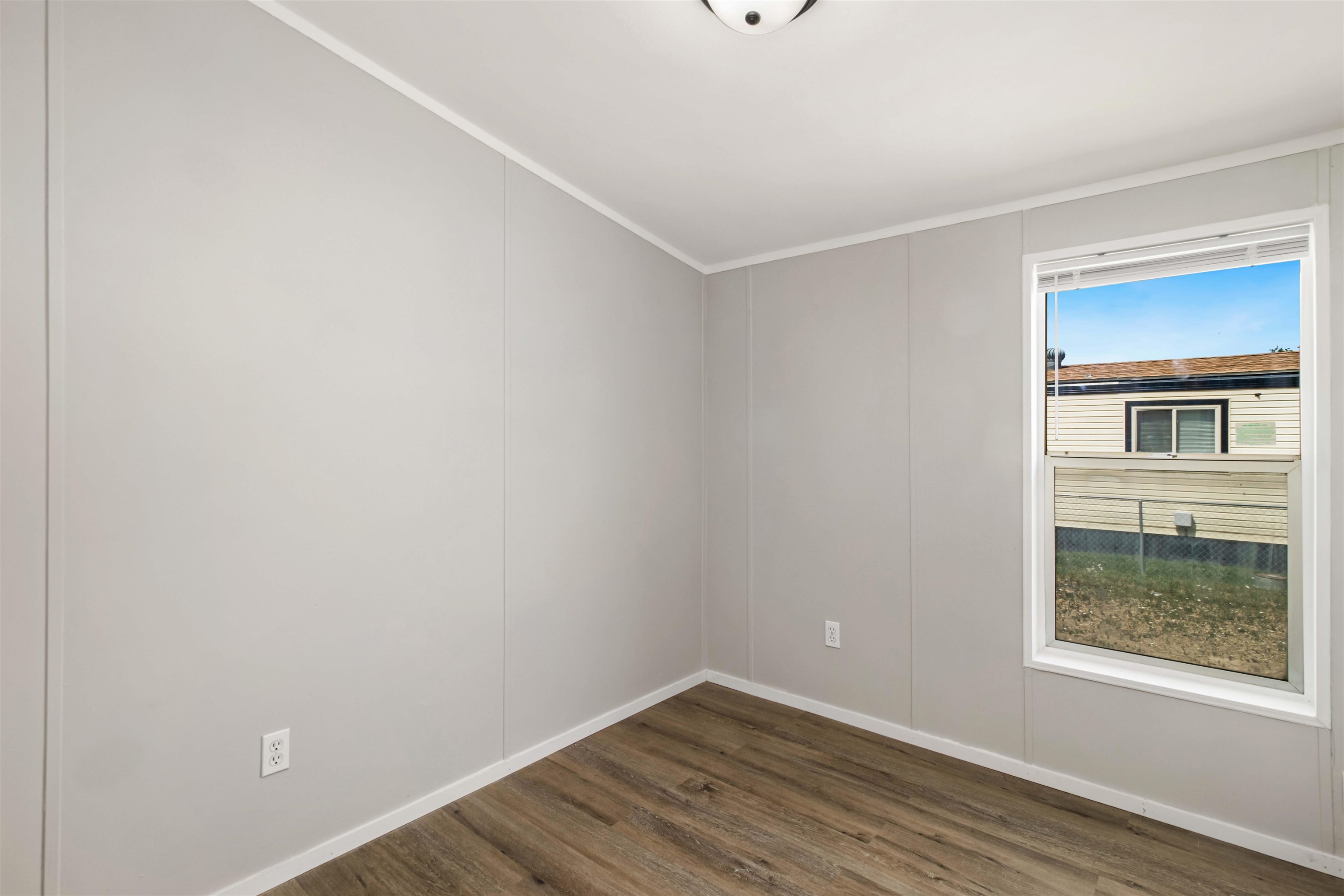 424 32 Road, Unit 85 Clifton, CO 81520 - Photo 5 of 12 a view of an empty room with wooden floor and a window