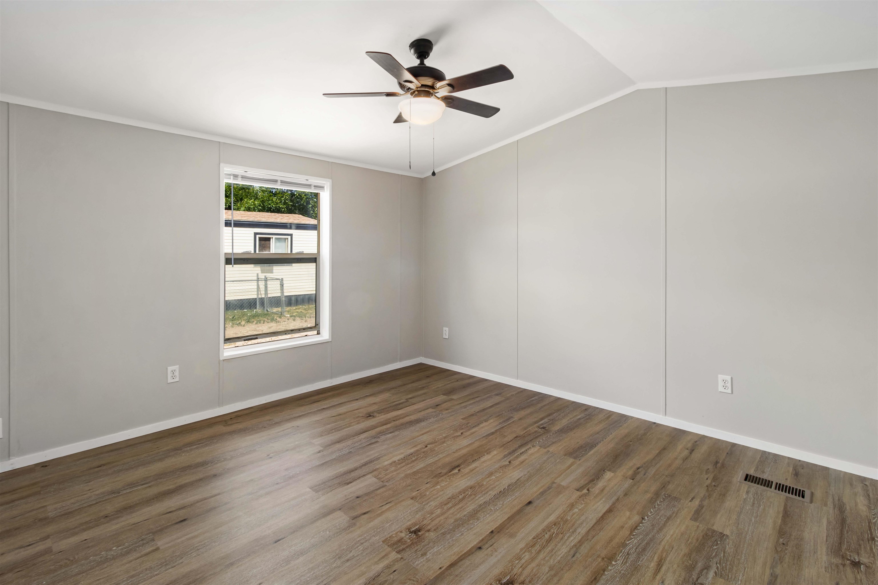424 32 Road, Unit 85 Clifton, CO 81520 - Photo 8 of 12 an empty room with wooden floor and windows