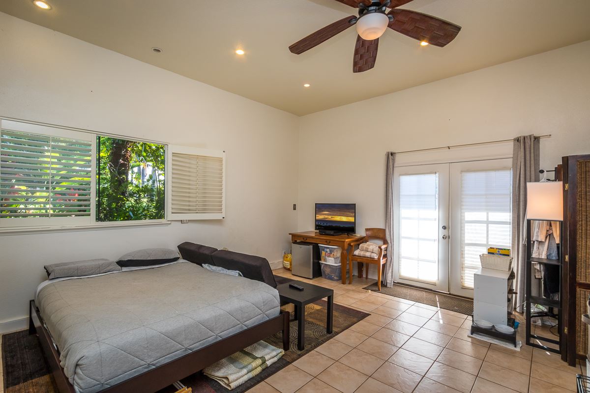 1320 West Kuiaha Road Haiku, HI 96708 - Photo 11 of 29 a bedroom with furniture and a window