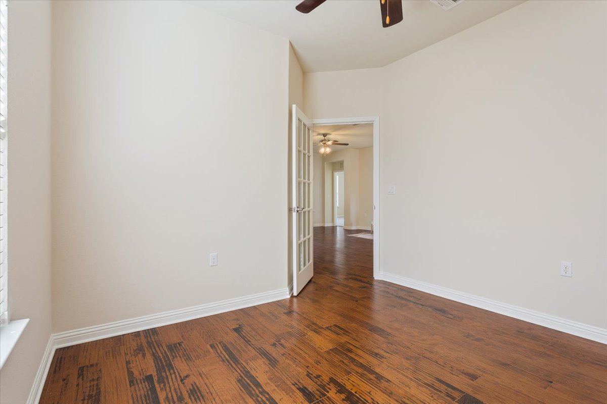 108 Cathedral Mountain Pass Georgetown, TX 78633 - Photo 17 of 36 a view of an empty room with wooden floor